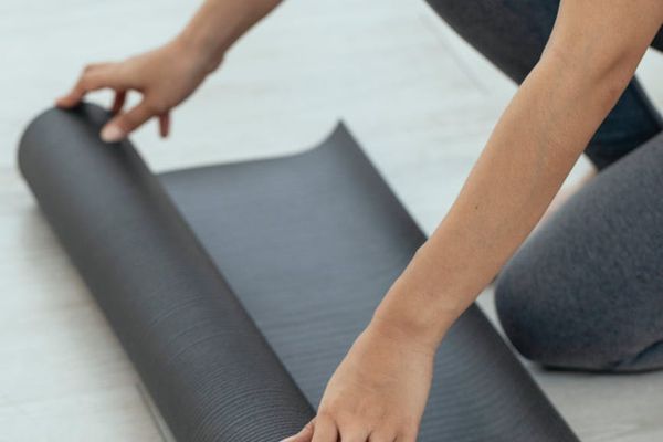 Empty, calm room with a mat ready for practice.